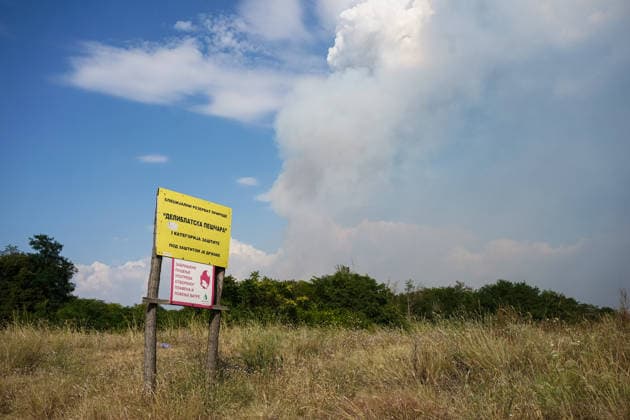 August 7, 2026, Sumarak, Vojvodina, Serbia: 202687, Sumarak, Serbia - Thick smoke rises above the landscape as a massive wildfire burns through the Deliblato Sands (Deliblatska Pescara) Special Nature Reserve. Helicopters of the Serbian Armed Forces are deployed to combat the blaze, using Bambi buckets to fetch water and extinguish the fire from the air. Deliblato Sands, often referred to as the European Sahara, is a strictly protected natural area. Sumarak Serbia - ZUMAd223 20260807_zip_d223_009 Copyright: xMarkoxDimicx