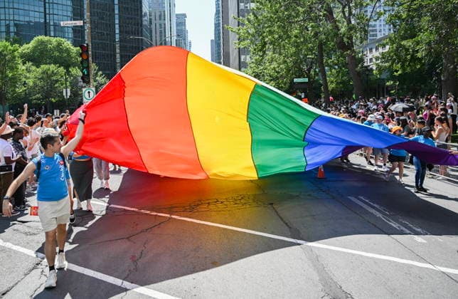 August 10, 2025, Montreal, Pq, Canada: Participants pull a rainbow flag along a street during the Pride parade in Montreal, Sunday, Aug. 10, 2025. Montreal Canada  - ZUMAc35_ 20250810_zaf_c35_028 Copyright: xGrahamxHughesx