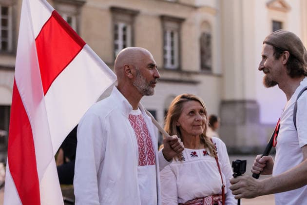 August 9, 2026, Warsaw, Poland: Participants talk to each other during an evening rally marking the sixth anniversary of the August 2020 presidential election in Belarus. An evening gathering marking the sixth anniversary of the August 2020 presidential election in Belarus was held near the Nicolaus Copernicus Monument in central Warsaw, bringing together leaders of Belarusian democratic forces, public figures and activists, as well as several hundred participants. Warsaw Poland  - ZUMAs197 20260809_aaa_s197_101 Copyright: xVolhaxShukailax