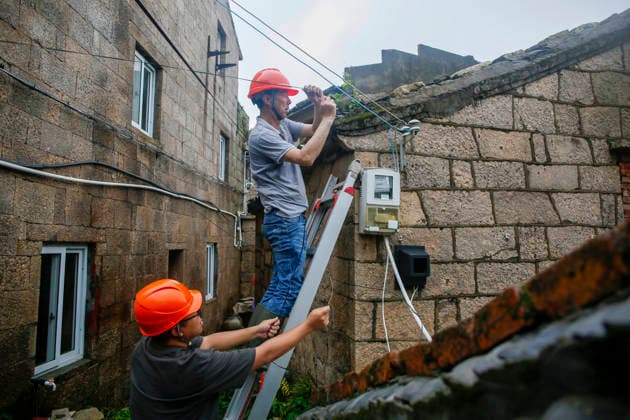 WENLING, CHINA - AUGUST 10: Staff members repair optical cables damaged by Typhoon Dolphin on August 10, 2026 in Wenling, Zhejiang Province of China. Heavy rainfall brought by Typhoon Dolphin caused severe waterlogging on roads and affecting residents travel. Typhoon Dolphin, the 13th typhoon of the year, made landfall at Yuhuan of Taizhou City, east China s Zhejiang Province, at around 5:30 p.m. on August 9.  Copyright: xVCGx 111659096991