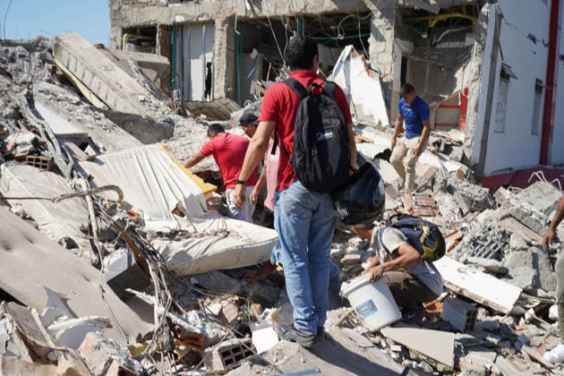 August 10, 2026, Cali, Valle Del Cauca, Colombia: People gather outside rubble of a collapsed building to search for survivors in Cali after a 7,4 Earthquake that struck Colombia on August 10, 2026. Cali Colombia - ZUMAvp1_ 20260810_zia_vp1_012 Copyright: xSebastianxMarmolejox