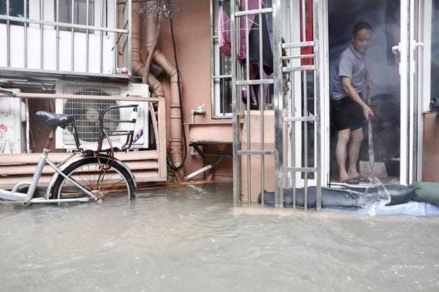 SHANGHAI, CHINA - AUGUST 10: Residents clean up indoor flooding on August 10, 2026 in Shanghai, China. Typhoon Dolphin that is yet to land already sent downpours to Shanghai on Sunday, flooding low-lying areas and disrupting air and rail travel across eastern China.  Copyright: xChinaxNewsxServicex 111659171271