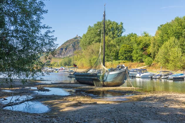 Niedrigwasser am Rhein: Aalschokker Aranka im trockengefallenen Nebenarm bei Insel Grafenwerth - 11.08.26. Niedrigwasser am Rhein: Bei einem Pegelstand von -3 cm am Pegel Oberwinter und 70 cm am Pegel Bonn neue Tiefstwerte liegt der Nebenarm an der Nordspitze der Insel Grafenwerth in Bad Honnef weitgehend trocken. Der historische Aalschokker Aranka liegt auf dem Trockenen, im Hintergrund die Grafenwerther Brücke und der Drachenfels. Die Rheinschifffahrt ist weiterhin stark eingeschränkt. Bad Honnef Insel Grafenwerth Nordrhein-Westfalen Deutschland Copyright: xMarcxJohnx