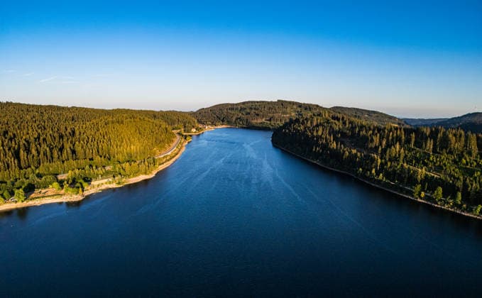 View over the Schluchsee in the evening sun Schluchsee, Germany - 12th Jul 2026: An aerial view from a drone perspective shows the Schluchsee in the Black Forest during the golden hour. The calm water is surrounded by dense coniferous forests. Copyright: xAndreasxHaasx