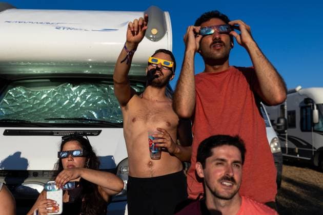 August 12, 2026, Paredes De Coura, Braga, Portugal: A group of festivalgoers wearing certified eclipse glasses watch the partial solar eclipse from the festival grounds during the opening day of Vodafone Paredes de Coura. Paredes De Coura Portugal - ZUMAs197 20260812_aaa_s197_599 Copyright: xDiogoxBaptistax