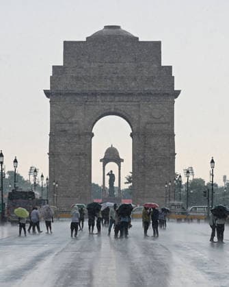 Heavy rain lashes parts of the National Capital New Delhi, Aug 13 (ANI): Visitors with umbrellas stand near India Gate amid heavy rainfall, in New Delhi on Thursday. New Delhi Delhi India Copyright: xANIx ANI_20260813286