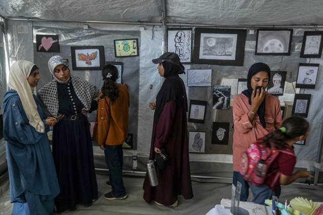 Palestinian children reflect war, displacement and hope through Art in Khan Yunis KHAN YUNIS, GAZA , PALESTINE - AUGUST 13: Works by Palestinian children are brought together in the exhibition held inside a tent at a refugee camp in the Al-Mawasi area of Khan Yunis, Gaza, Palestine on August 13, 2026. Created amid the severe humanitarian conditions resulting from the attacks that have continued since Oct. 2023, the artworks depict the children s experiences of displacement, destruction, hunger, water shortages and the loss of loved ones. Abed Rahim Khatib Anadolu Han Yunus Palestinian Territory, Occupied. Editorial use only. Please get in touch for any other usage.  Copyright: x2026xAnadoluxAbedxRahimxKhatibx