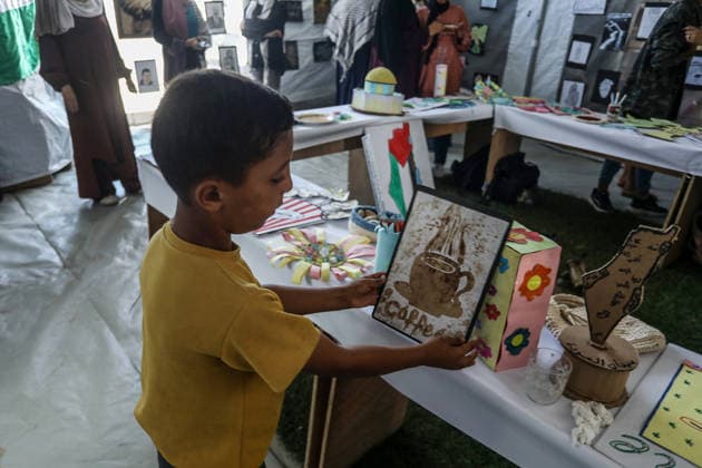 Palestinian children reflect war, displacement and hope through Art in Khan Yunis KHAN YUNIS, GAZA , PALESTINE - AUGUST 13: Works by Palestinian children are brought together in the exhibition held inside a tent at a refugee camp in the Al-Mawasi area of Khan Yunis, Gaza, Palestine on August 13, 2026. Created amid the severe humanitarian conditions resulting from the attacks that have continued since Oct. 2023, the artworks depict the children s experiences of displacement, destruction, hunger, water shortages and the loss of loved ones. Abed Rahim Khatib Anadolu Han Yunus Palestinian Territory, Occupied. Editorial use only. Please get in touch for any other usage.  Copyright: x2026xAnadoluxAbedxRahimxKhatibx