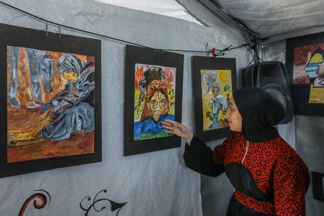 Palestinian children reflect war, displacement and hope through Art in Khan Yunis KHAN YUNIS, GAZA , PALESTINE - AUGUST 13: Works by Palestinian children are brought together in the exhibition held inside a tent at a refugee camp in the Al-Mawasi area of Khan Yunis, Gaza, Palestine on August 13, 2026. Created amid the severe humanitarian conditions resulting from the attacks that have continued since Oct. 2023, the artworks depict the children s experiences of displacement, destruction, hunger, water shortages and the loss of loved ones. Abed Rahim Khatib Anadolu Han Yunus Palestinian Territory, Occupied. Editorial use only. Please get in touch for any other usage. Copyright: x2026xAnadoluxAbedxRahimxKhatibx