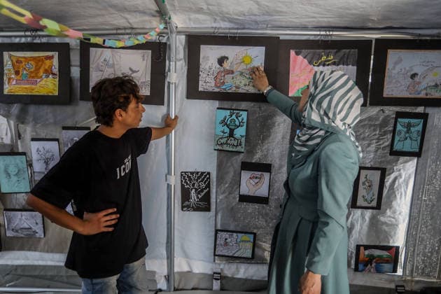 Palestinian children reflect war, displacement and hope through Art in Khan Yunis KHAN YUNIS, GAZA , PALESTINE - AUGUST 13: Works by Palestinian children are brought together in the exhibition held inside a tent at a refugee camp in the Al-Mawasi area of Khan Yunis, Gaza, Palestine on August 13, 2026. Created amid the severe humanitarian conditions resulting from the attacks that have continued since Oct. 2023, the artworks depict the children s experiences of displacement, destruction, hunger, water shortages and the loss of loved ones. Abed Rahim Khatib Anadolu Han Yunus Palestinian Territory, Occupied. Editorial use only. Please get in touch for any other usage.  Copyright: x2026xAnadoluxAbedxRahimxKhatibx