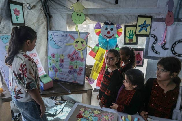 Palestinian children reflect war, displacement and hope through Art in Khan Yunis KHAN YUNIS, GAZA , PALESTINE - AUGUST 13: Works by Palestinian children are brought together in the exhibition held inside a tent at a refugee camp in the Al-Mawasi area of Khan Yunis, Gaza, Palestine on August 13, 2026. Created amid the severe humanitarian conditions resulting from the attacks that have continued since Oct. 2023, the artworks depict the children s experiences of displacement, destruction, hunger, water shortages and the loss of loved ones. Abed Rahim Khatib Anadolu Han Yunus Palestinian Territory, Occupied. Editorial use only. Please get in touch for any other usage.  Copyright: x2026xAnadoluxAbedxRahimxKhatibx
