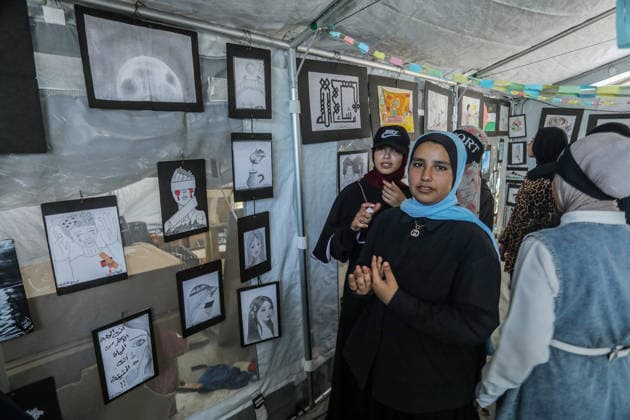 Palestinian children reflect war, displacement and hope through Art in Khan Yunis KHAN YUNIS, GAZA , PALESTINE - AUGUST 13: Works by Palestinian children are brought together in the exhibition held inside a tent at a refugee camp in the Al-Mawasi area of Khan Yunis, Gaza, Palestine on August 13, 2026. Created amid the severe humanitarian conditions resulting from the attacks that have continued since Oct. 2023, the artworks depict the children s experiences of displacement, destruction, hunger, water shortages and the loss of loved ones. Abed Rahim Khatib Anadolu Han Yunus Palestinian Territory, Occupied. Editorial use only. Please get in touch for any other usage. Copyright: x2026xAnadoluxAbedxRahimxKhatibx