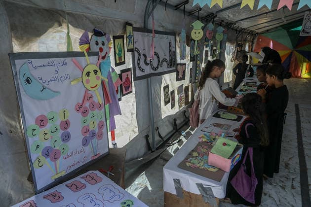 Palestinian children reflect war, displacement and hope through Art in Khan Yunis KHAN YUNIS, GAZA , PALESTINE - AUGUST 13: Works by Palestinian children are brought together in the exhibition held inside a tent at a refugee camp in the Al-Mawasi area of Khan Yunis, Gaza, Palestine on August 13, 2026. Created amid the severe humanitarian conditions resulting from the attacks that have continued since Oct. 2023, the artworks depict the children s experiences of displacement, destruction, hunger, water shortages and the loss of loved ones. Abed Rahim Khatib Anadolu Han Yunus Palestinian Territory, Occupied. Editorial use only. Please get in touch for any other usage.  Copyright: x2026xAnadoluxAbedxRahimxKhatibx