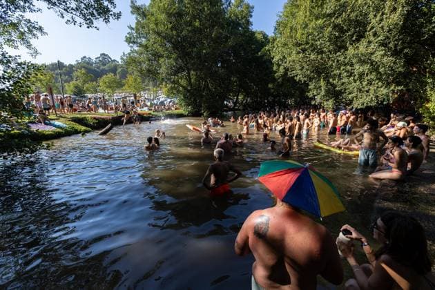 August 13, 2026, Paredes De Coura, Braga, Portugal: Festivalgoers swim in the river Coura water known locally as Couraiso during daytime at Vodafone Paredes de Coura. Paredes De Coura Portugal - ZUMAs197 20260813_aab_s197_012 Copyright: xDiogoxBaptistax