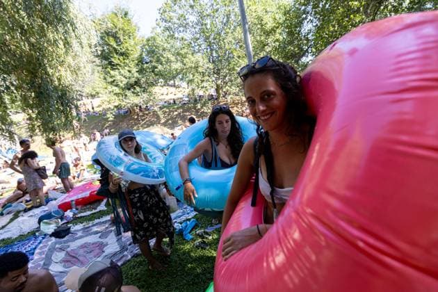 August 13, 2026, Paredes De Coura, Braga, Portugal: Festivalgoers gather with inflatable rings at the river Coura known locally as Couraiso during the daytime at Vodafone Paredes de Coura. Paredes De Coura Portugal - ZUMAs197 20260813_aab_s197_017 Copyright: xDiogoxBaptistax