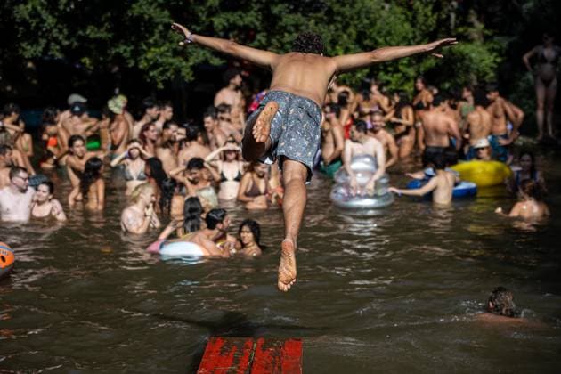 August 13, 2026, Paredes De Coura, Braga, Portugal: A festivalgoer jumps into the river Coura known locally as Couraiso while others gather in the water during the daytime at Vodafone Paredes de Coura. Paredes De Coura Portugal - ZUMAs197 20260813_aab_s197_018 Copyright: xDiogoxBaptistax