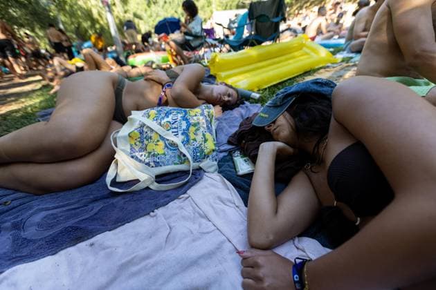 August 13, 2026, Paredes De Coura, Braga, Portugal: Festivalgoers rest on the grass at the river Coura known locally as Couraiso during the daytime at Vodafone Paredes de Coura. Paredes De Coura Portugal - ZUMAs197 20260813_aab_s197_021 Copyright: xDiogoxBaptistax