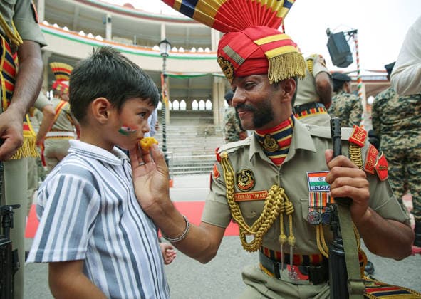 RECORD DATE NOT STATED 80th Independence Day celebrations at the Attari Wagha border Amritsar, Aug 15 (ANI): A Border Security Force (BSF) soldier offers sweet to a child during the Beating Retreat ceremony on the occasion of 80th Independence Day, at Attari Wagha border, in Amritsar on Saturday. Amritsar Punjab India Copyright: xANIx ANI_20260815435