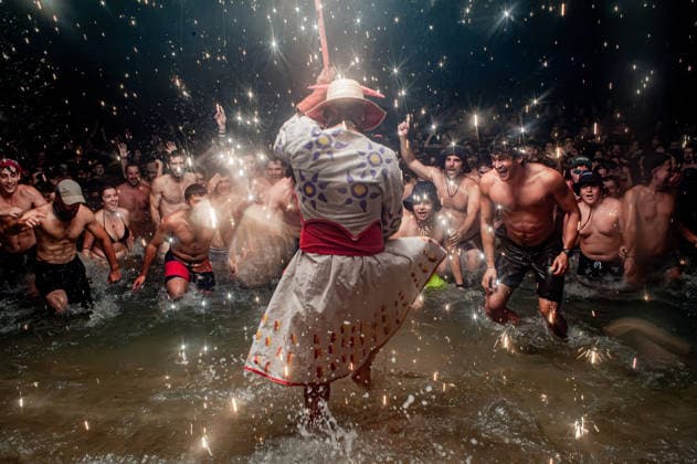 August 15, 2026, Badalona, Spain: People react as a Correfoc devil enters the sea during the August Festival in Badalona, north of Barcelona. The Correfoc, a traditional Catalan celebration featuring fireworks and fire-spitting performers, ends in the waters of Badalona beach. Badalona Spain - ZUMAb137 20260815_fap_b137_018 Copyright: xJordixBoixareux