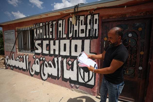 August 16, 2026, Masafer Yatta, Palestine, State of: MASAFER YATTA, WEST BANK, PALESTINE, AUGUST 16, 2026: Palestinian Abdullah Dababseh holds his phone displaying a demolition order issued by the Israeli army for the cave where he lives in Khirbet Khallet Al-Dabaa, south of Hebron. According to local residents, demolition orders were issued for three homes, three caves, a school, trees and crops in the area. Residents said the village was demolished in May 2025, forcing some Palestinians to live in caves. Masafer Yatta Palestine, State of - ZUMAq101 20260816_zna_q101_096 Copyright: xMosabxShawerx