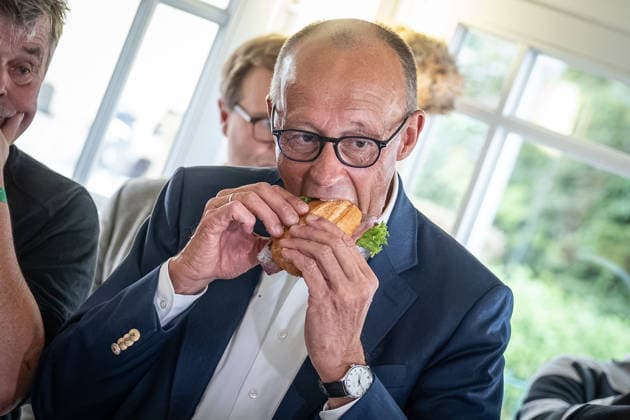Fischbrötchen-Essen im Fischladen Fisch-Hus an der Strandpromenade - Bundeskanzler Friedrich Merz isst ein Fischbrötchen;Bundeskanzler mit CDU-Spitzenkandidat im Wahlkampf zur Landtagswahl Mecklenburg-Vorpommern 2026 in Kühlungsborn, Kühlungsborn Mecklenburg-Vorpommern Deutschland ORTSANGABE