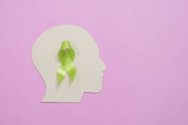 Konzept zur Sensibilisierung und Unterstützung im Bereich der psychischen Gesundheit mit einer grünen Schleife in Form einer Kopfsilhouette auf rosafarbenem Hintergrund Mental health awareness and support concept with a green bow in the shape of a head silhouette on a pink background Copyright: imageBROKER NATEExMEEPIAN ibxiqx18656263.jpg
