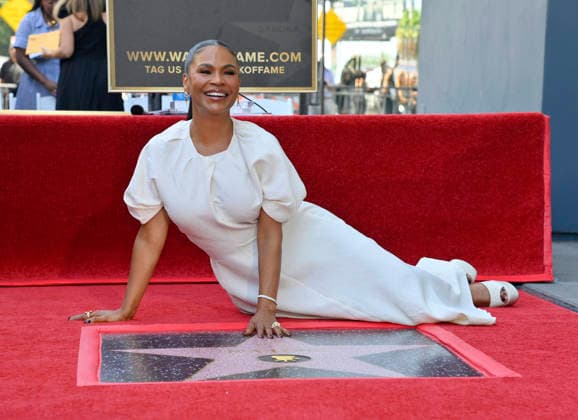Actress Nia Long lies next to her star during an unveiling ceremony honoring her with the 2,857th star on the Hollywood Walk of Fame in Los Angeles on Wednesday, September 16, 2026.  LAP2026091601 JIMxRUYMEN