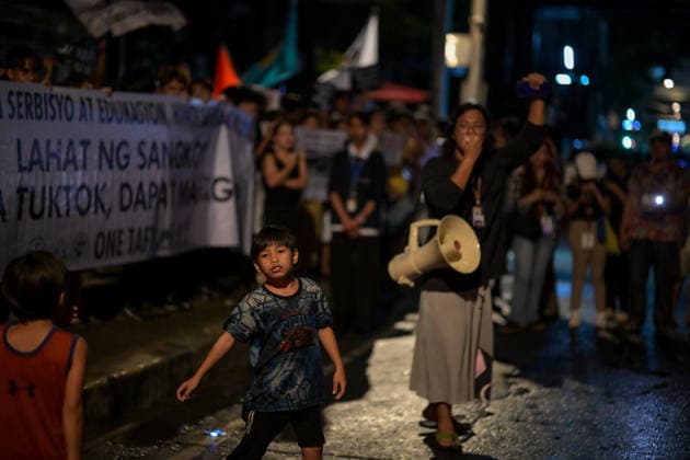 September 18, 2026, Philippines: Two kids curious about the event of Black Friday Protest on Friday at Taft Ave, Metro Manila. It coincided with the Black Friday Protests from different universities and a preparation for the mass movement on Sept. 21 for the Martial Law anniversary. Among the calls were for the alleged human rights abuses, corruption, and the Pax Silica initiative under the administration of President Ferdinand Marcos Jr. Philippines  - ZUMAr240 20260918_zip_r240_012 Copyright: xMarcxDominicxRostratax