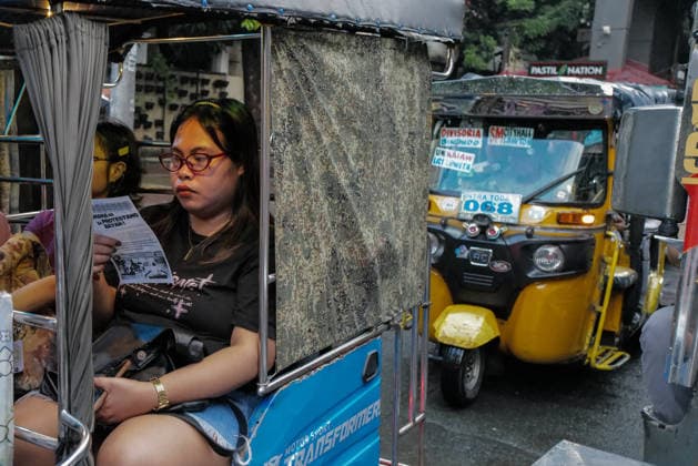 September 18, 2026, Philippines: A passenger reads the pamphlet given by the students during the Black Friday Protest by One Taft, a coalition of Taft-based schools, on Friday at Taft Ave, Metro Manila. It coincided with the Black Friday Protests from different universities and a preparation for the mass movement on Sept. 21 for the Martial Law anniversary. Among the calls were for the alleged human rights abuses, corruption, and the Pax Silica initiative under the administration of President Ferdinand Marcos Jr. Philippines - ZUMAr240 20260918_zip_r240_030 Copyright: xMarcxDominicxRostratax