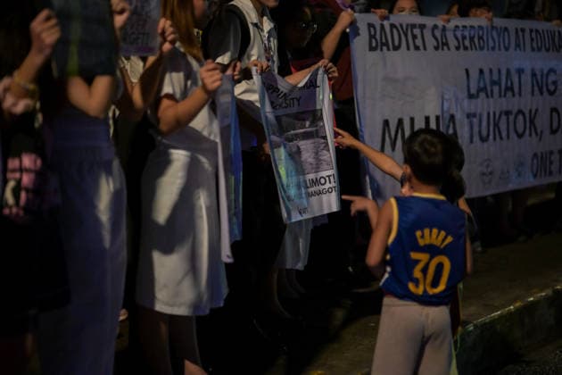 September 18, 2026, Philippines: Two kids curious about the protests signs during Black Friday Protest on Friday at Taft Ave, Metro Manila. It coincided with the Black Friday Protests from different universities and a preparation for the mass movement on Sept. 21 for the Martial Law anniversary. Among the calls were for the alleged human rights abuses, corruption, and the Pax Silica initiative under the administration of President Ferdinand Marcos Jr. Philippines - ZUMAr240 20260918_zip_r240_011 Copyright: xMarcxDominicxRostratax
