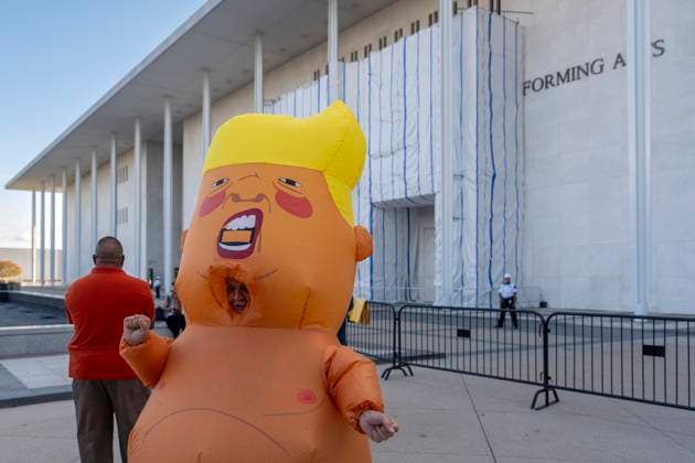 September 18, 2026, Washington, Dc, USA: A person dressed as Donald Trump stands outside the Kennedy center during the Hands Around the Kennedy Center demonstration..Supporters of the Kennedy Center gathered for the protest in response to this week s escalating tensions over the arts institution s future, including the Trump-appointed board voting to close the center in defiance of a court order, testimony that contractors were ramming the pillars of the building with construction equipment, and photographs showing President Trump aboard Air Force One with a poster that read Kennedy Center DEMOLISHED Washington USA  - ZUMAs197 20260918_aaa_s197_056 Copyright: xJenxGolbeckx