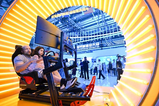 2026 WMC Held in Hefei HEFEI, CHINA - SEPTEMBER 20, 2026 - A foreign visitor with a child was experiencing the simulated cockpit at the 2026 World Manufacturing Convention in Binhu International Convention Center, Hefei City, Anhui Province on September 20, 2026. Hefei Anhui China  Copyright: xCFOTOx i1789926044528