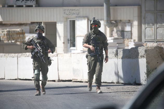 September 20, 2026, Nablus, West Bank, Palestine: Israeli soldiers seen walking along a street near a military checkpoint following a vehicle-ramming attack carried out by a Palestinian near an Israeli military base south of the city. The incident resulted in the death of one Palestinian and the injury of another by army fire. The Israeli army had closed roads southeast of Jenin and blocked the route connecting to other Palestinian cities. Nablus Palestine - ZUMAs197 20260920_aaa_s197_244 Copyright: xNasserxIshtayehx