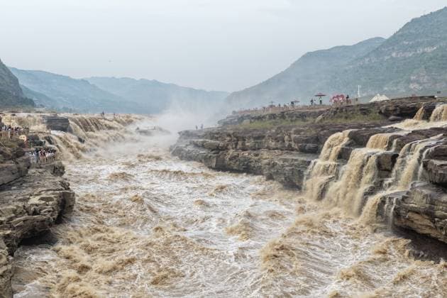 YAN AN, CHINA - SEPTEMBER 20: The water volume of the Hukou Waterfall on the Yellow River rises significantly due to sand flushing and flood discharge from upstream reservoirs on September 20, 2026 in Yan an, Shaanxi Province of China. The flow rate reached 1,800 cubic meters per second, merging the main and side waterfalls into a continuous line and attracting numerous tourists to view the scenery.  Copyright: xVCGx 111668265448