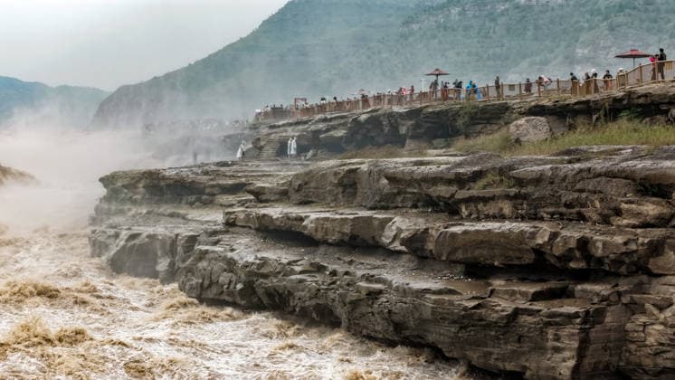 YAN AN, CHINA - SEPTEMBER 20: The water volume of the Hukou Waterfall on the Yellow River increases significantly due to sediment discharge and flood release from upstream reservoirs on September 20, 2026 in Yan an, Shaanxi Province of China. The flow rate reached 1,800 cubic meters per second, merging the main and side waterfalls into a continuous line that attracted tourists to view the scenery.  Copyright: xVCGx 111668265441
