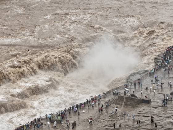 YAN AN, CHINA - SEPTEMBER 20: Visitors watch the rising water volume at the Hukou Waterfall on the Yellow River on September 20, 2026 in Yan an, Shaanxi Province of China. Influenced by sediment flushing and flood discharge from reservoirs in the middle and upper reaches, the waterfall s flow rate reached 1,800 cubic meters per second, merging the main and side falls into a continuous line.  Copyright: xVCGx 111668265435
