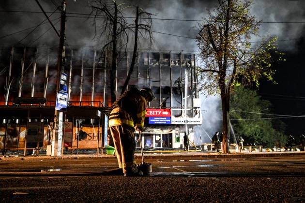 A firefighter rolls out of a fire hose during a response effort to a fire in the Intrade shopping centre caused by an overnight Russian drone attack, Zaporizhzhia, Ukraine, September 21, 2026. On Monday night, Russian forces struck the southeastern city with strike UAVs and an FPV drone. The attack destroyed the shopping centre and damaged a university building as well as multi-storey residential blocks. Six people were injured. (Photo by Dmytro Smolienko Ukrinform) Russian army attacks shopping mall with drones in Zaporizhzhia  Copyright: xDmytroxSmolienkox