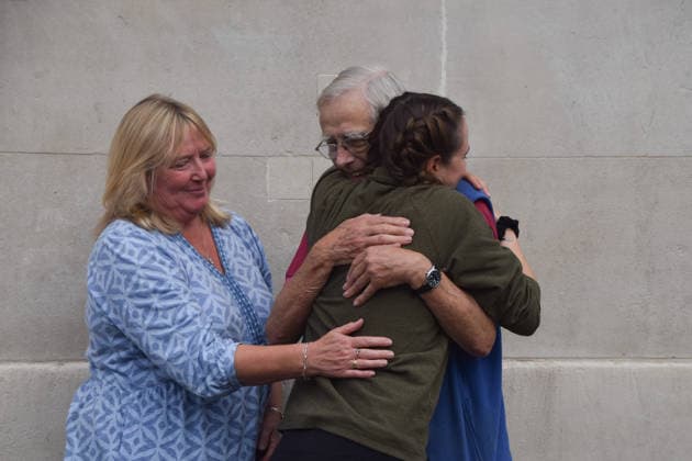 September 22, 2026, London, England, United Kingdom: The activist MICHELLE FARNHAM hugs members of her family after leaving the farrowing crate in Trafalgar Square on the final day of a protest against pig crates and factory farms organised by the animal rights group Animal Rising. The activist lived in the crate for three weeks, demonstrating how mother pigs live on factory farms, and calling for an end to farrowing crates and a pig named Luna to be freed. London United Kingdom - ZUMAv130 20260922_zip_v130_010 Copyright: xVukxValcicx