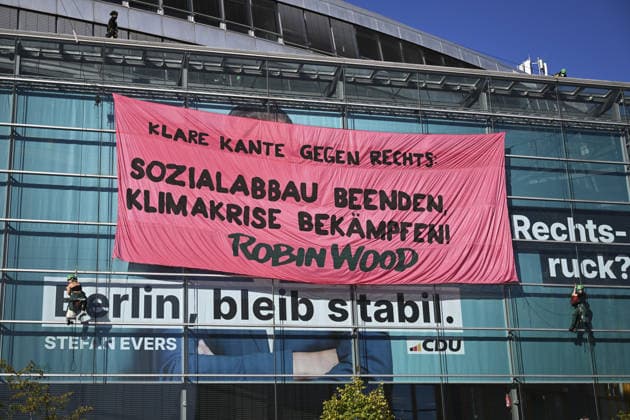 Environmental activists protest at CDU headquarters in Berlin BERLIN, GERMANY - SEPTEMBER 23: Environmental activists stage a protest at the Christian Democratic Union (CDU) headquarters, displaying banners on the building facade, in Berlin, Germany, on September 23, 2026. ROBIN WOOD activists climbed the CDU headquarters and unfurled the banner, criticizing the CDU-led federal government over what they described as insufficient action on climate protection and a lack of measures to counter the rise of the far-right Alternative for Germany (AfD). Halil Sagirkaya Anadolu Berlin Germany. Editorial use only. Please get in touch for any other usage.  Copyright: x2026xAnadoluxHalilxSagirkayax