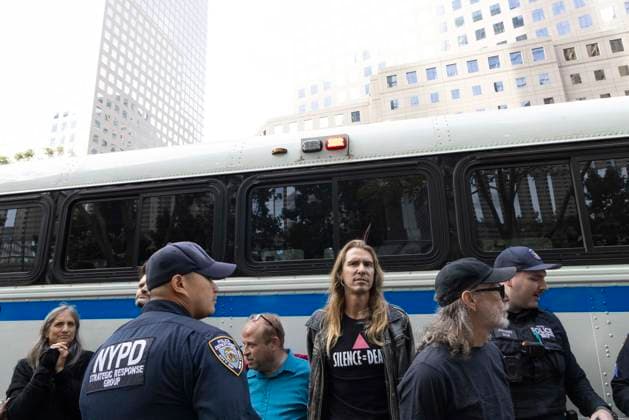 September 23, 2026, New York, New York, USA: ACT UP leads a coalition of organizations blockading the entrance to 1 WTC and later blocking traffic on the West Side Highway demonstrating under the banner AI OUT OF OUR HEALTHCARE! PALANTIR OUT OF MOUNT SINAI! as the Newsweek AI Health Summit is held inside the building and a keynote speaker is Dr. Brendan Carr, (not pictured) CEO of Mount Sinai. Arrestees are taken to a police bus after approximately 20 protesters are arrested by NYPD. Part of the MONEY FOR AIDS and HEALTHCARE! NOT FOR ICE and WARFARE! ACT UP (AIDS Coalition To Unleash Power) campaign, demonstrators denounce Mount Sinai s contract with Palantir, a surveillance, data analytics and military tech company. New York USA - ZUMAr174 20260923_znp_r174_052 Copyright: xGinaxMxRandazzox