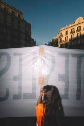 September 23, 2026, Barcelona, Catalonia, Spain: September 23, 2026, Barcelona, Spain: A protester holds up a banner, seen from behind against the evening light. Hundreds of people gathered in front of the Spanish Government Delegation in Catalonia, on Mallorca Street in Barcelona, at a protest against evictions called by tenants and housing unions, including the Sindicat de Llogateres, the Barcelona Tenants Union. The protest followed the eviction that morning in Madrid of MARICARMEN, an 87-year-old woman forced out of the rented flat where she had lived for seventy years, and the death of OLGA, a woman from L Hospitalet de Llobregat who took her own life after being evicted. The unions warned that they will call a general strike if the - ZUMAs392 20260923_zip_s392_005 Copyright: xFabianxSuspensivox