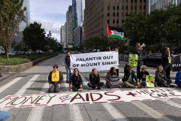 September 23, 2026, New York, New York, USA: Demonstrators sit in the road and block traffic on the West Side Highway. ACT UP NY leads a coalition of organizations blockading the entrance to 1 WTC and later the Highway, demonstrating under the banner AI OUT OF OUR HEALTHCARE! PALANTIR OUT OF MOUNT SINAI! as the Newsweek AI Health Summit is held inside the building and a keynote speaker is Dr. Brendan Carr, (not pictured) CEO of Mount Sinai. Approximately 20 protesters are arrested. Part of the MONEY FOR AIDS and HEALTHCARE! NOT FOR ICE and WARFARE! ACT UP (AIDS Coalition To Unleash Power) campaign, demonstrators denounce Mount Sinai s contract with Palantir, a surveillance, data analytics and military tech company. New York USA  - ZUMAr174 20260923_znp_r174_039 Copyright: xGinaxMxRandazzox