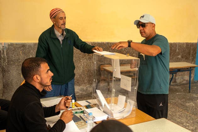 September 23, 2026, Essaouira, Morocco: A man casts his vote as election officials handle a ballot box during parliamentary elections in Essaouira, Morocco. Essaouira Morocco - ZUMAz174 20260923_zip_z174_006 Copyright: xMoexZoyarix