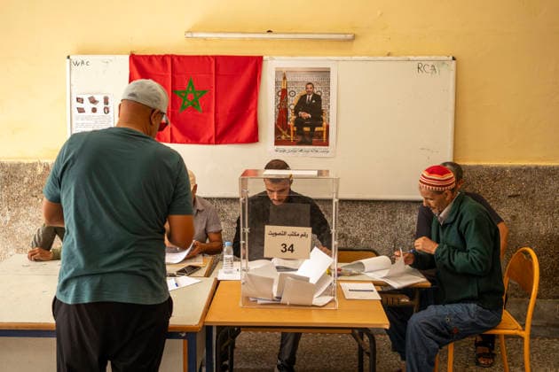 September 23, 2026, Essaouira, Morocco: Officials sit at a registration table beneath a Moroccan flag during parliamentary elections in Essaouira, Morocco. Essaouira Morocco - ZUMAz174 20260923_zip_z174_007 Copyright: xMoexZoyarix
