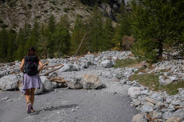 Vehicles Evacuated by Helicopter After Floods - France A woman walks along a section of the RD204T buried under rocks, mud and fallen trees. Nine vehicles stranded at the Pre de Madame Carle were evacuated by helicopter after floods on August 28 destroyed several sections of the RD204T access road. Ailefroide, Vallouise-Pelvoux, Hautes-Alpes, France, September 24, 2026. Photo by Thibaut Durand ABACAPRESS.COM vallouise-pelvoux PROVENCE-ALPES-COTE D AZUR France  Copyright: xDurandxThibaut ABACAx