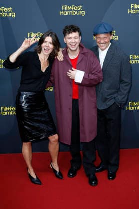 Malgorzata Szumowska, Christian Friedel und Michal Englert bei der Festivaleröffnung mit der Premiere des Kinofilms The Idiot(s) auf dem 34. Filmfest Hamburg 2026 im Cinemaxx Dammtor. Hamburg, 24.09.2026