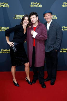 Malgorzata Szumowska, Christian Friedel und Michal Englert bei der Festivaleröffnung mit der Premiere des Kinofilms The Idiot(s) auf dem 34. Filmfest Hamburg 2026 im Cinemaxx Dammtor. Hamburg, 24.09.2026