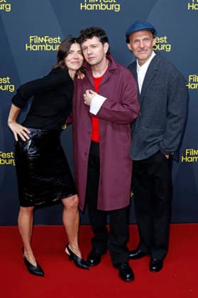 Malgorzata Szumowska, Christian Friedel und Michal Englert bei der Festivaleröffnung mit der Premiere des Kinofilms The Idiot(s) auf dem 34. Filmfest Hamburg 2026 im Cinemaxx Dammtor. Hamburg, 24.09.2026