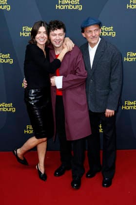 Malgorzata Szumowska, Christian Friedel und Michal Englert bei der Festivaleröffnung mit der Premiere des Kinofilms The Idiot(s) auf dem 34. Filmfest Hamburg 2026 im Cinemaxx Dammtor. Hamburg, 24.09.2026