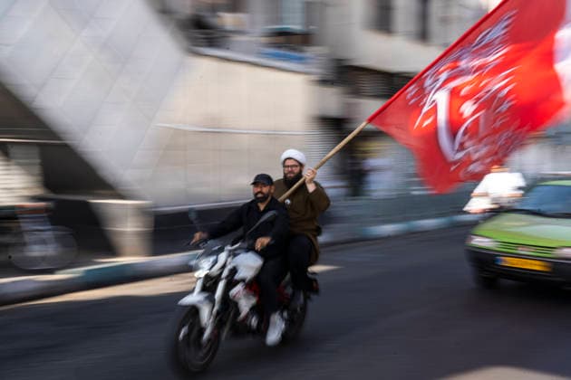 September 25, 2026, Tehran, Iran: An Iranian cleric holds a flag while riding on a motorcycle during the 40,000-strong Sacrifice for Iran motorcycle rally. Tehran Iran  - ZUMAs197 20260925_aaa_s197_011 Copyright: xFoadxAshtarix
